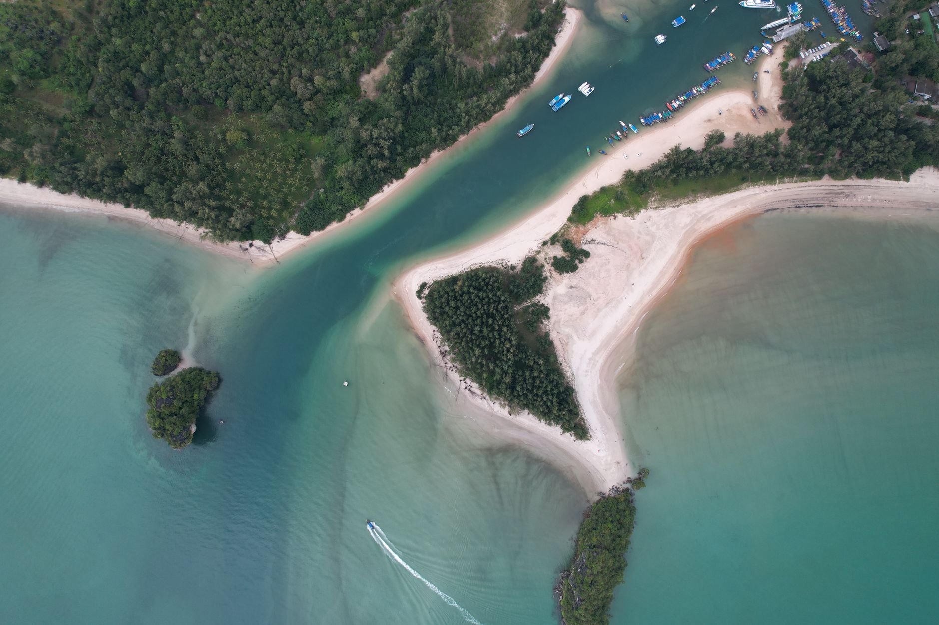 Aerial view of a tropical island with lush greenery and turquoise water
